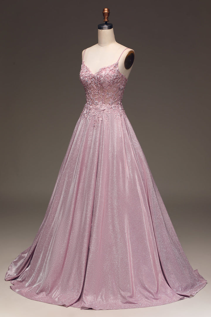Detail of the bodice and embellishments of a women's light pink maxi dress, perfect occasion wear.