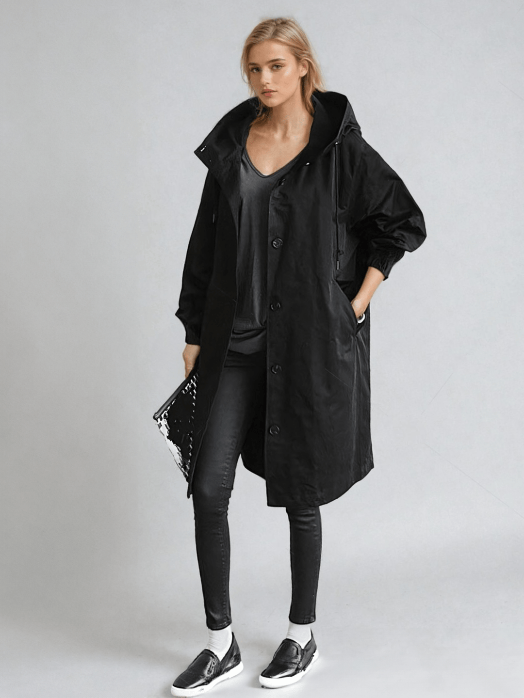 Elegant women's trench coat, water-repellent, showcasing stylish long outerwear. Ideal for casual chic fashion.