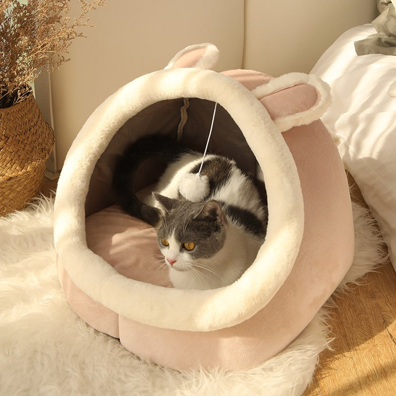 Plush pink Feline Cozy Cave Bed, a snug cat house & pet hideaway. Provides ultimate comfort for your feline.