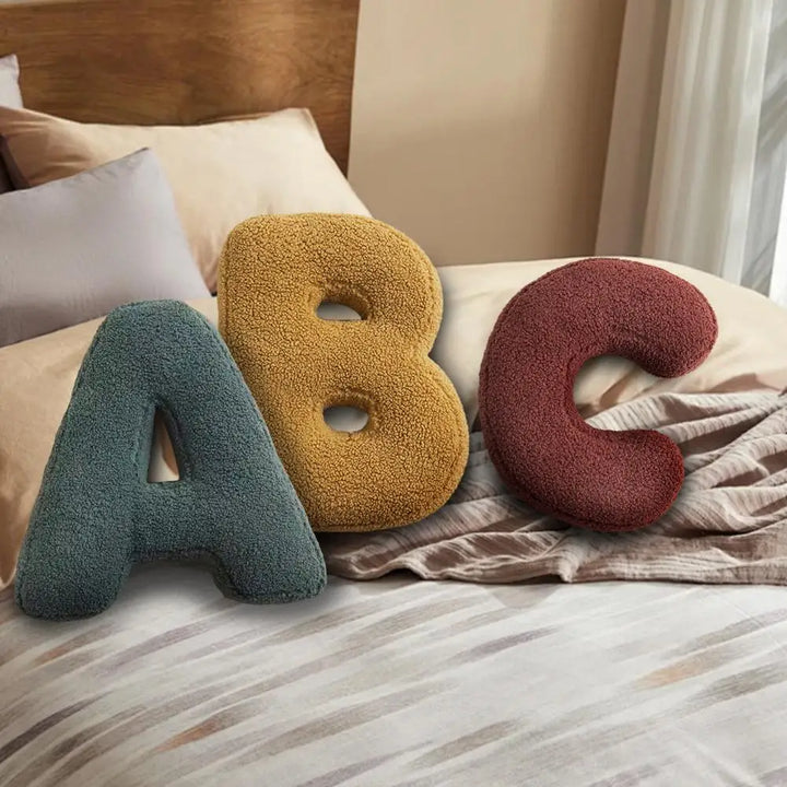 Soft velvet initial pillow, a personalized decorative accent for any room.