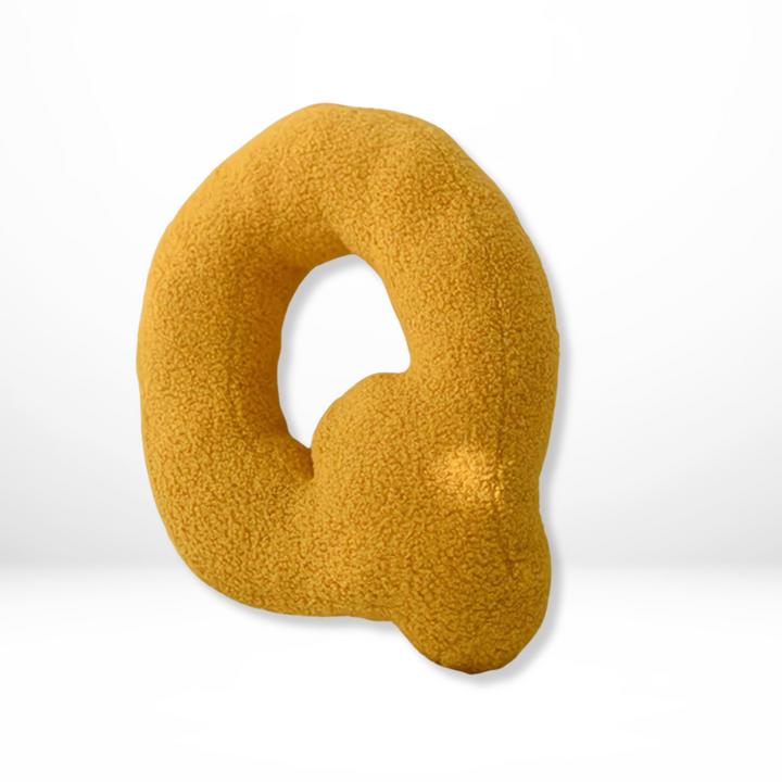 Designer velvet alphabet pillow, a unique focal point for any stylish setting.