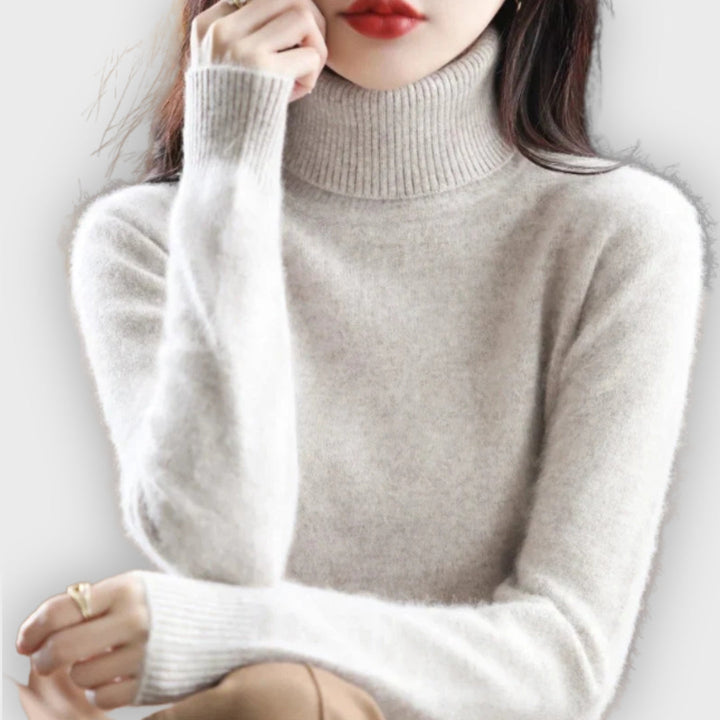 Close-up of a cozy women's roll neck sweater, showcasing luxurious knit texture & warmth.
