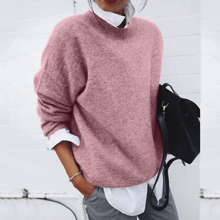Woman wearing a casual long sleeve modern knit sweater. Comfortable & versatile pullover for everyday fall fashion.