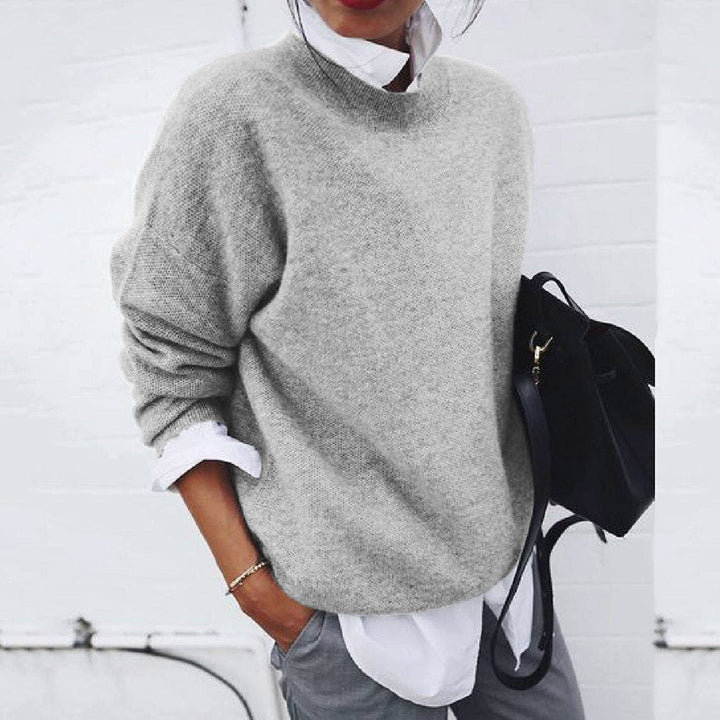 Elegant woman in a luxurious modern knit sweater. A timeless pullover, essential for sophisticated winter fashion.