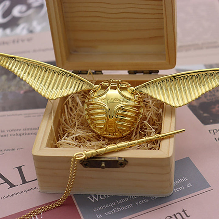 Gold-plated winged orb keepsake box, versatile as a ring holder, jewelry case, or elegant decorative accent.