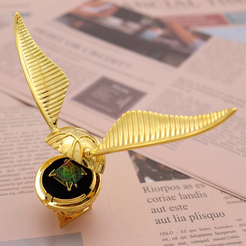 Elegant gold-plated winged orb ring box, a unique fantasy decor piece & luxury jewelry storage.