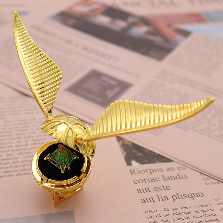 Elegant gold-plated winged orb ring box, a unique fantasy decor piece & luxury jewelry storage.