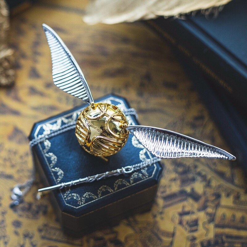 Intricate golden winged orb decorative box, ideal for collectors, fantasy decor & elegant home accents.