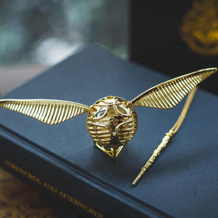Fantasy-inspired golden winged orb decorative box, offering elegant storage for jewelry & small mementos.