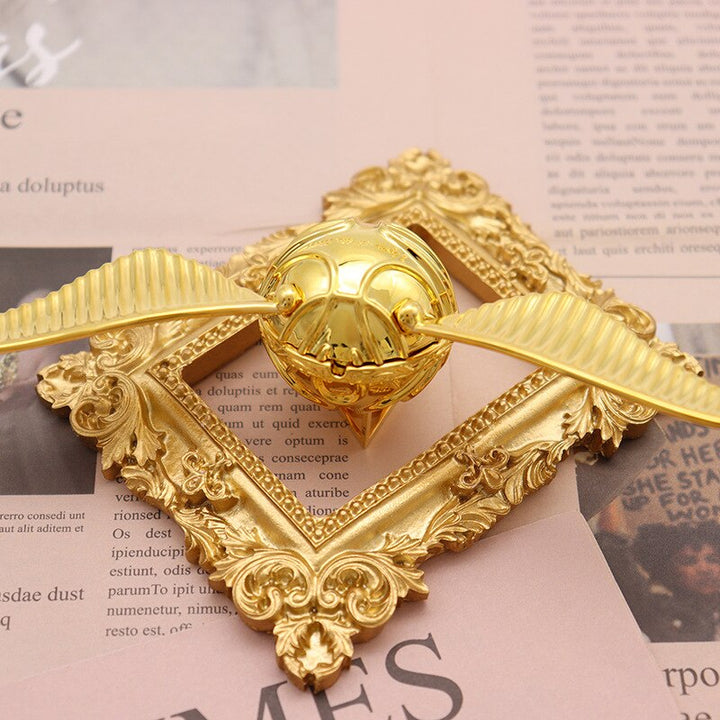 A luxurious golden winged orb gift box, an elegant & unique way to present rings or precious jewels.