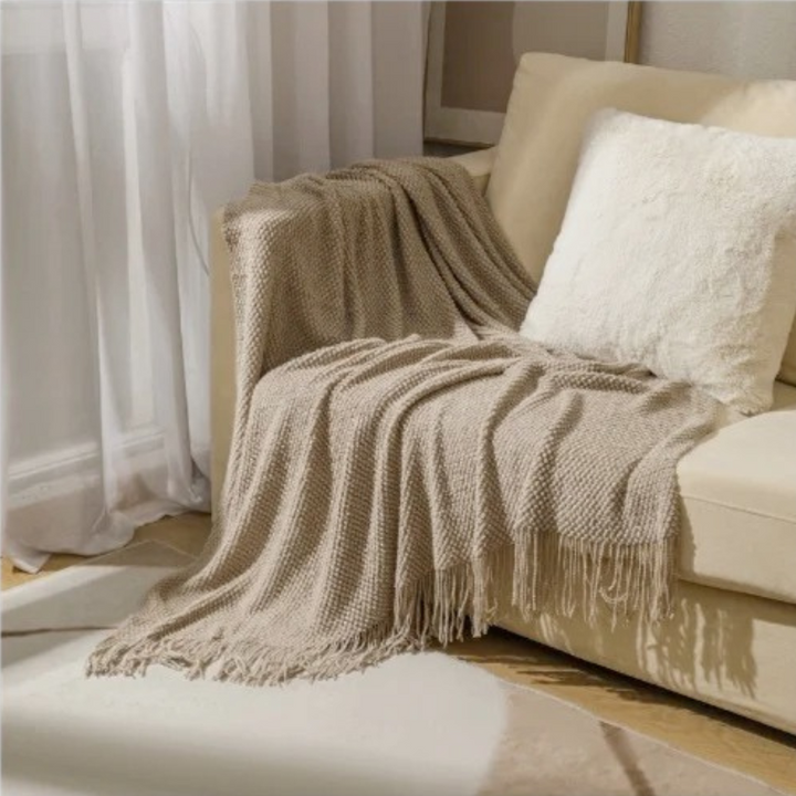 Soft, comfort acrylic throw blanket with tassels, ideal for modern home decor in bedroom.
