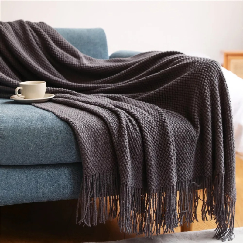 Elegant Merino-Style throw blanket featuring tassels, adding luxury and warmth to any space.