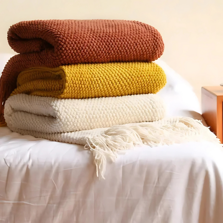 Modern luxury throw blanket, soft acrylic with stylish tassels, for bedroom or living room decor.
