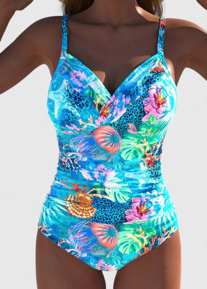 Stylish women's one-piece swimsuit with vibrant tropical print, perfect for beachwear.