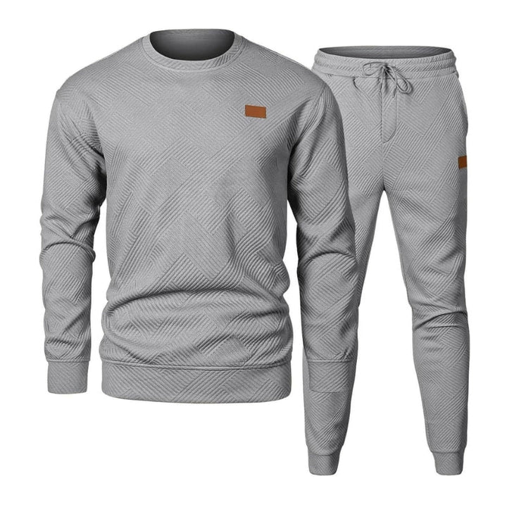 Complete men's active two-piece tracksuit for all-day comfort, includes a top and drawstring waist joggers.
