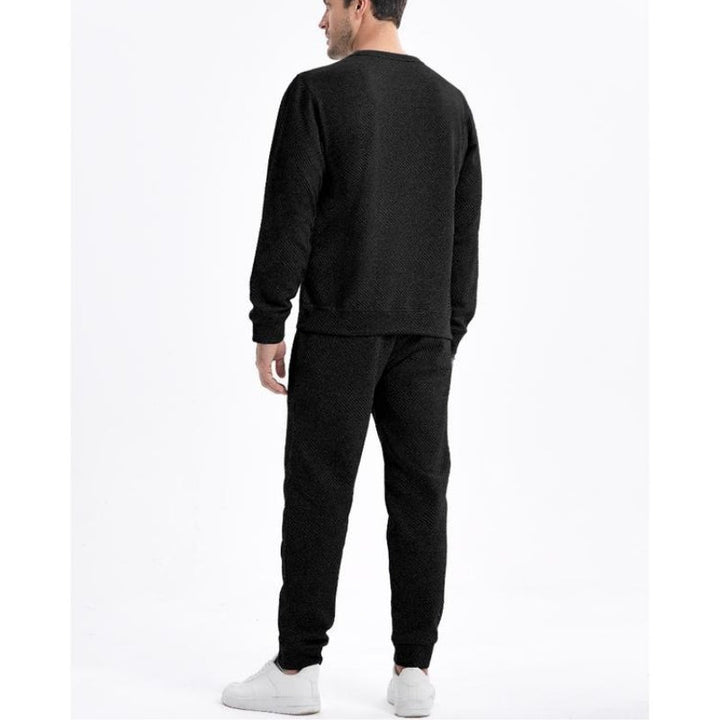 Trendy men's tracksuit set: a cozy sweatshirt and joggers with drawstring waist, ideal for streetwear fashion.