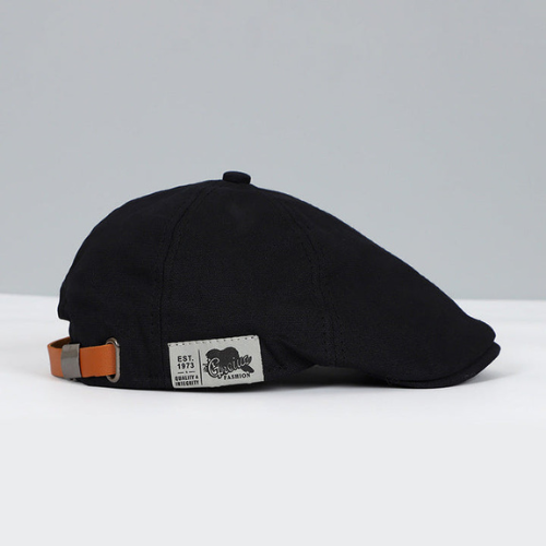 Man wearing an adjustable black beret, showcasing modern and elegant fashion headwear