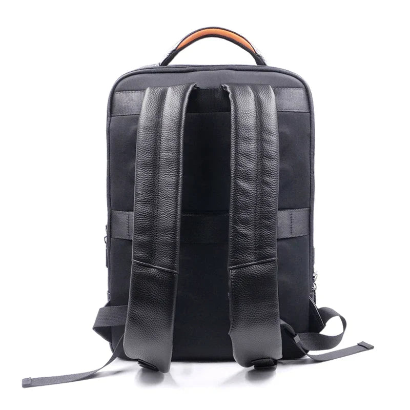 Close-up of a men's black leather commuter backpack, highlighting the integrated fingerprint lock.