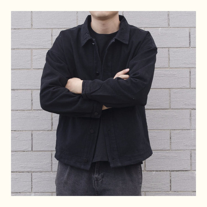 Relaxed fit men's button-down casual jacket with front pockets, versatile outerwear piece.