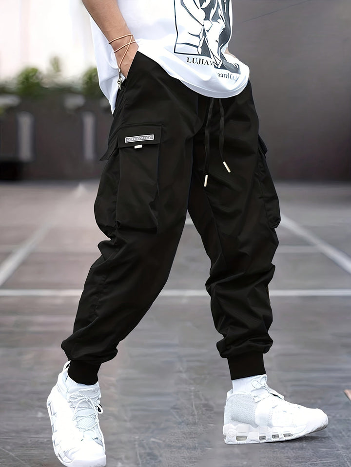 Men's black drawstring cargo jogger pants with side pockets, ideal for streetwear and casual wear.