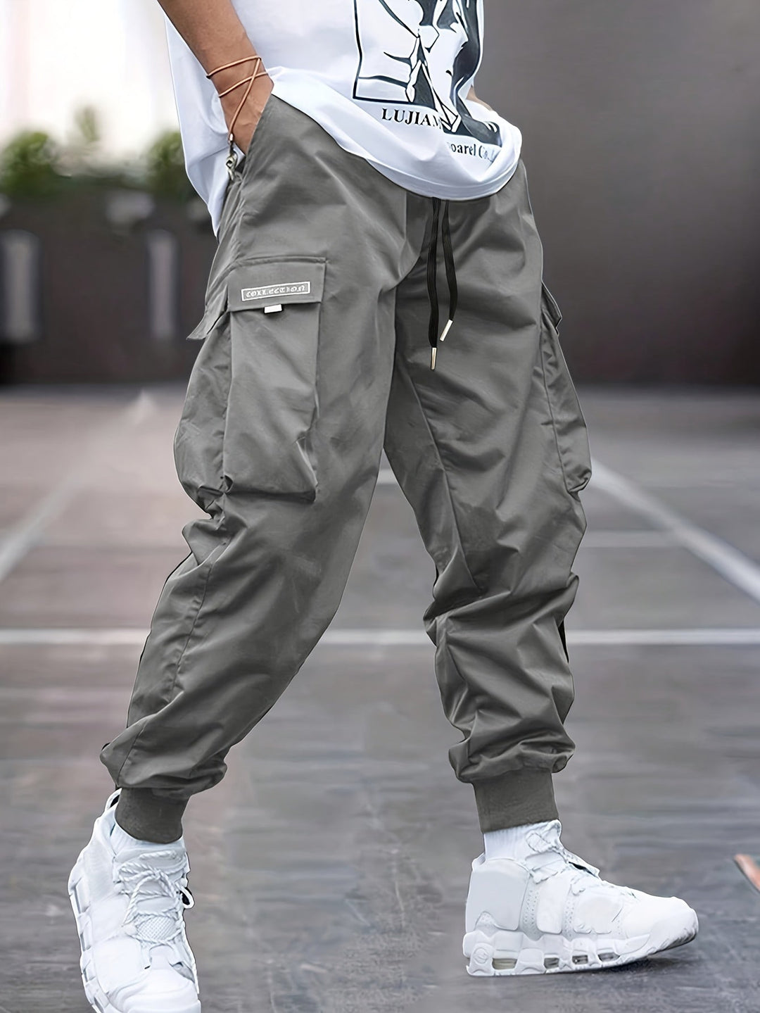 Dark grey men's cargo jogger pants featuring a drawstring waist, perfect for comfortable summer fashion.