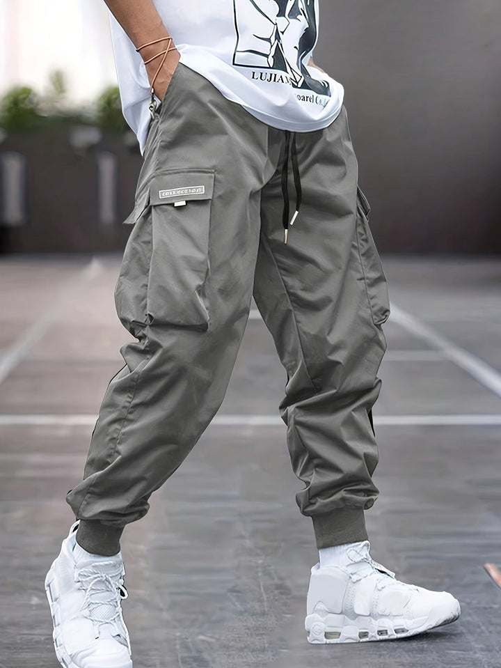 Dark grey men's cargo jogger pants featuring a drawstring waist, perfect for comfortable summer fashion.