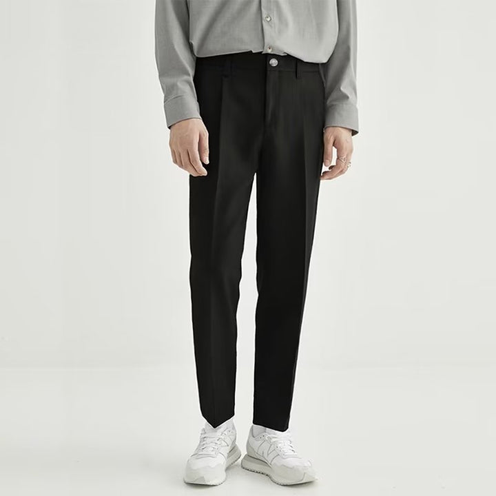 Men's black high-waisted pleated cropped dress pants, perfect for modern smart casual looks.