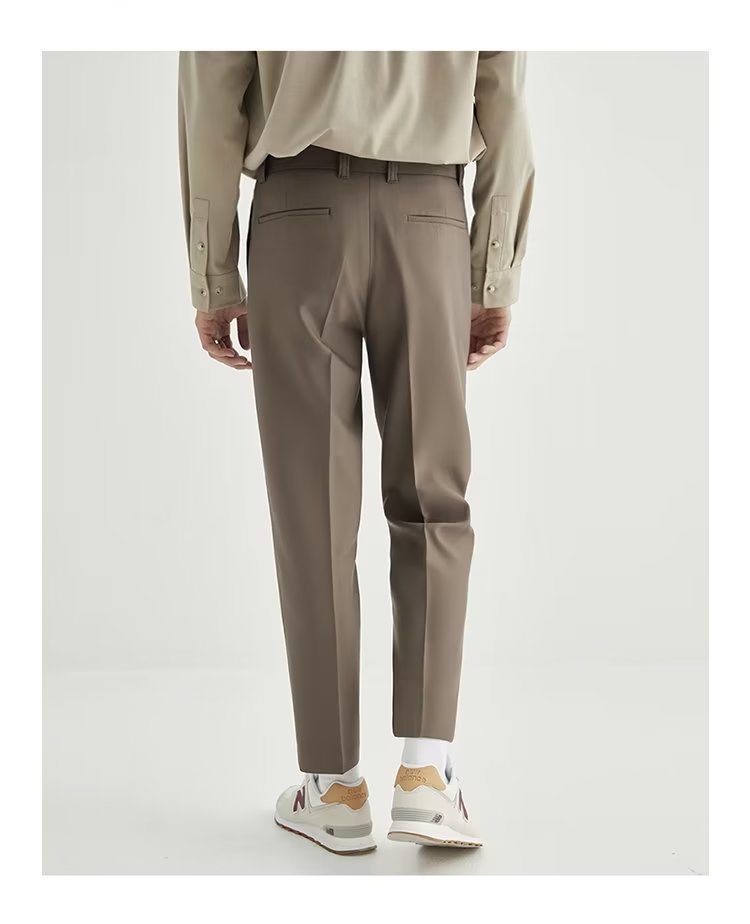 Khaki high-waisted pleated cropped men's trousers, ideal for smart casual or contemporary outfits.