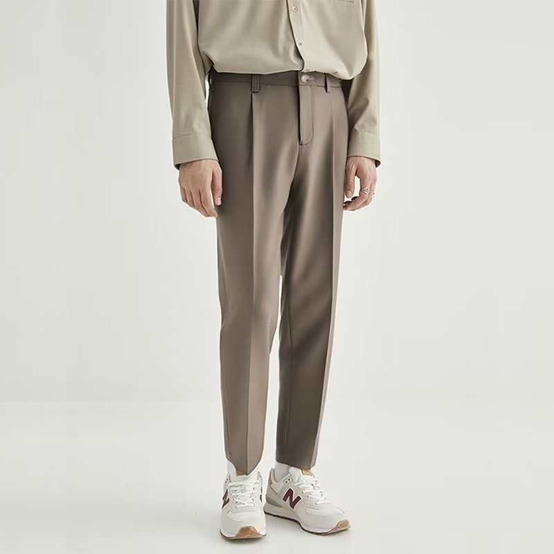 Light grey men's pleated cropped dress pants, high-waisted design for a sleek, modern aesthetic.