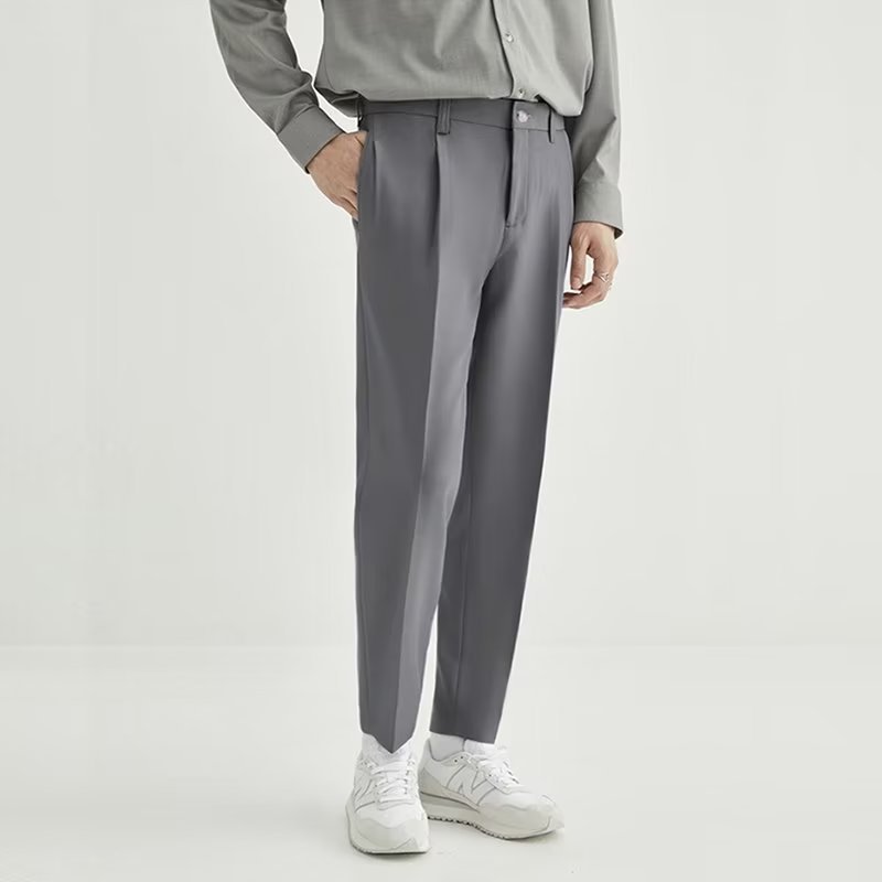 Modern men's brown high-waisted pleated cropped trousers, offering a smart casual and comfortable style.