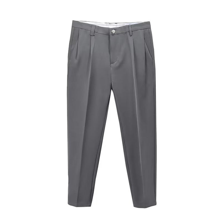 Chic light grey high-waisted pleated cropped pants for men, blending dressy with contemporary flair.
