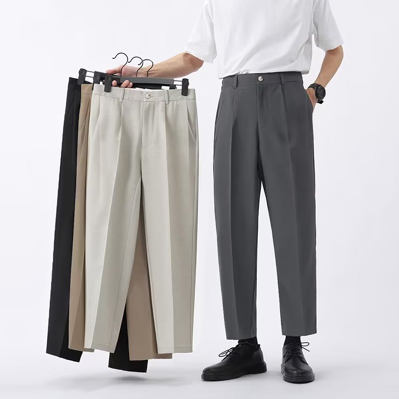 Classic khaki men's high-waisted pleated cropped dress pants, offering a sharp and modern silhouette.
