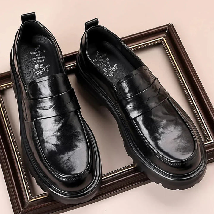 Classic men's black moc toe slip-on loafers with penny strap, offering comfort and timeless style.
