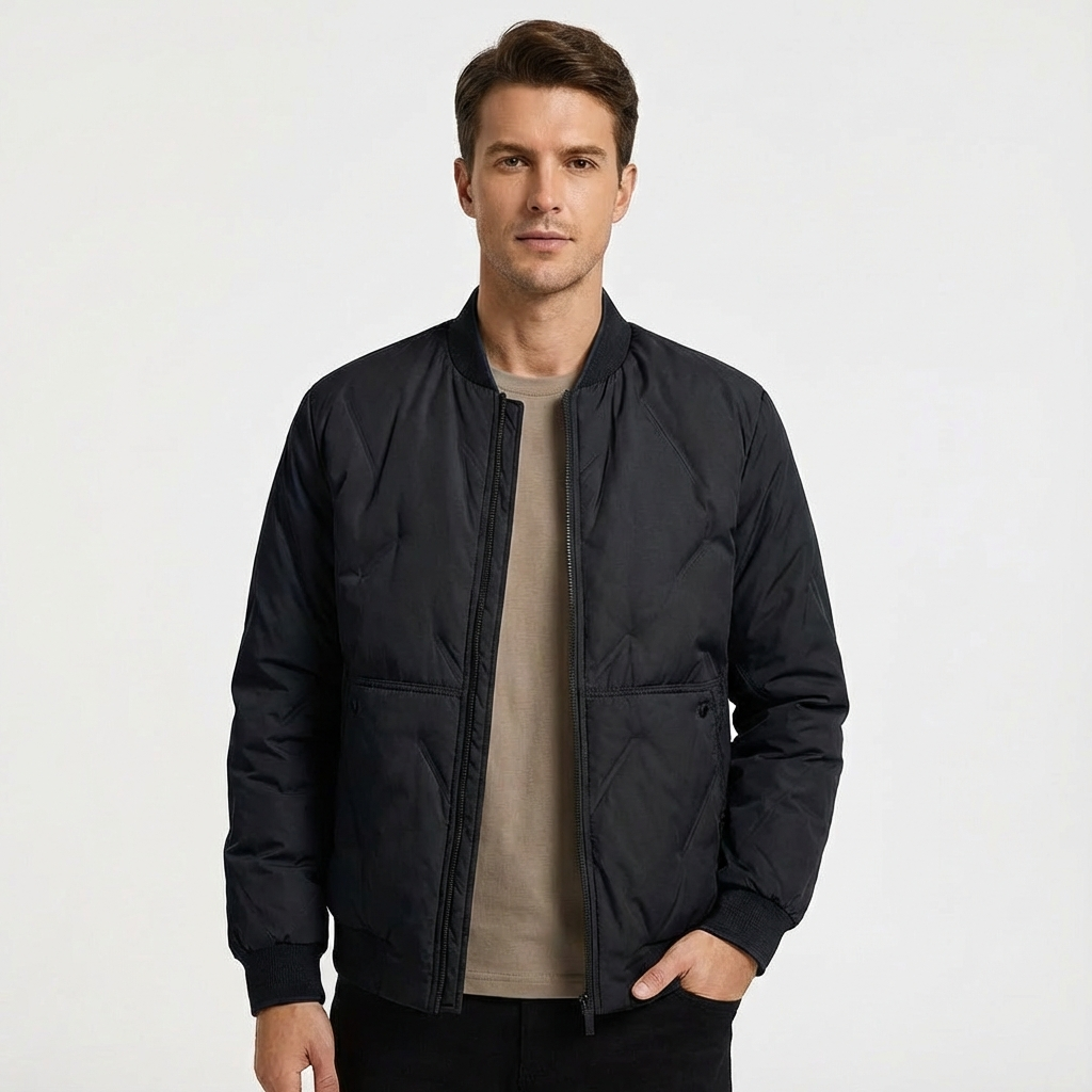 Man in a black quilted bomber jacket. Casual zip-front style, ideal everyday outerwear for fall/spring.