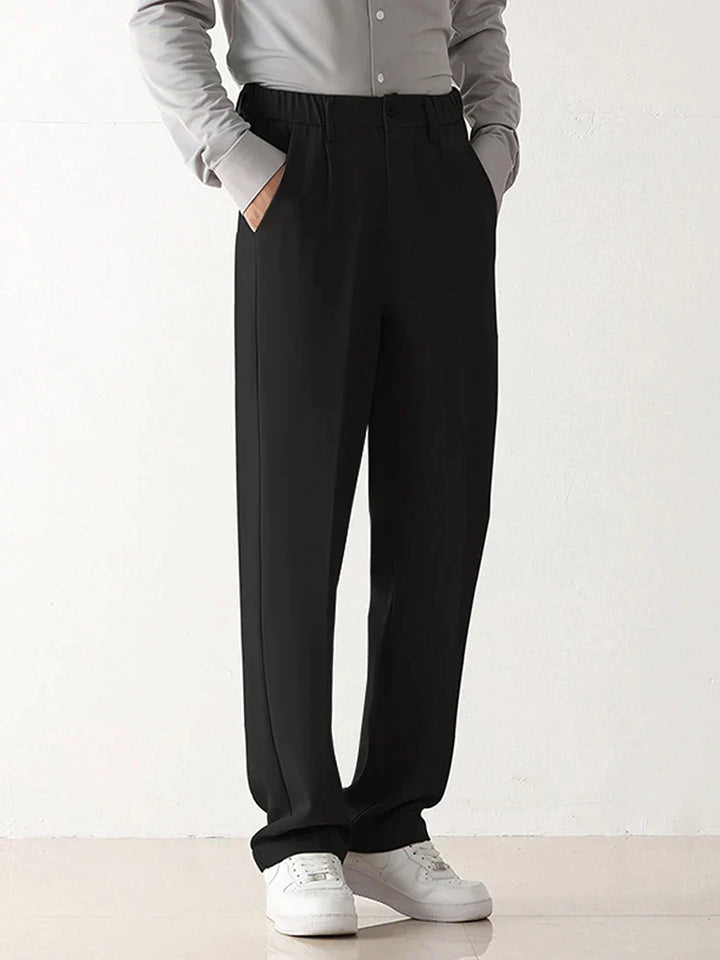 Modern men's black draped chinos with a relaxed fit and tailored finish, great for contemporary business fashion.
