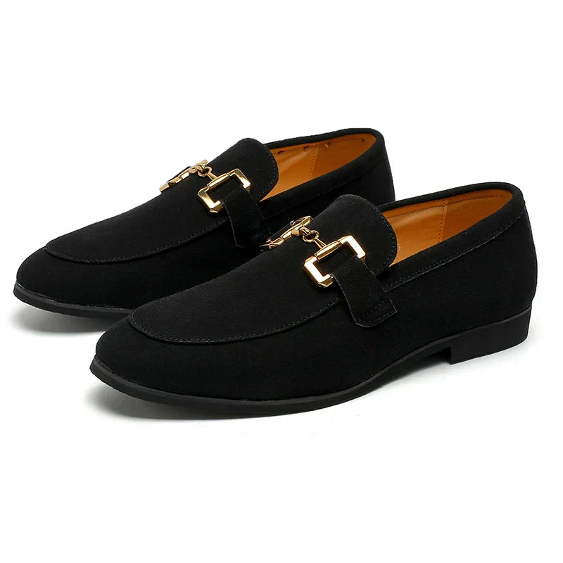 Detailed view of men's slip-on loafers, highlighting the modern metal accent and comfortable design.