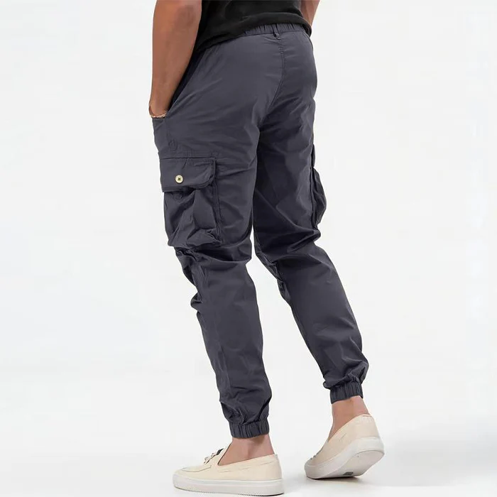 Functional men's cargo pants in olive green with drawstring waist, ideal for outdoor comfort.