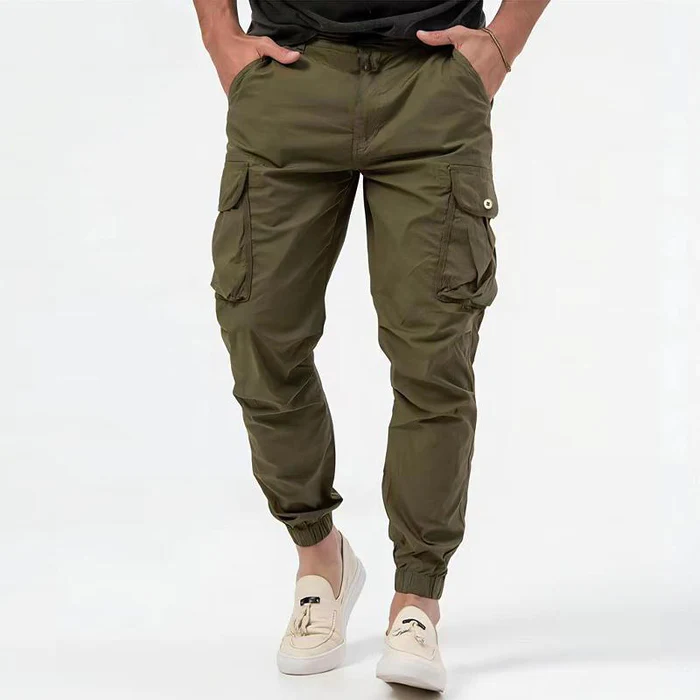 Front view of men's beige utility cargo pants, showcasing drawstring waist and roomy fit.