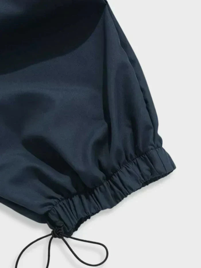 Close-up of fabric and pocket detail on men's wide leg utility cargo pants, streetwear style
