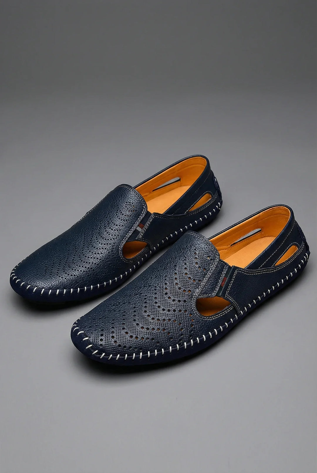 Stylish men's perforated slip-on loafers in navy blue for ultimate breathability & summer casual comfort.