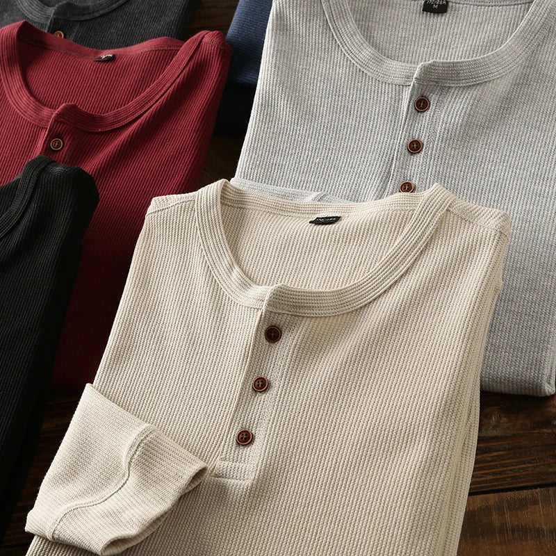 Minimalist men's waffle knit Henley shirt, breathable & smart for modern casual wear.