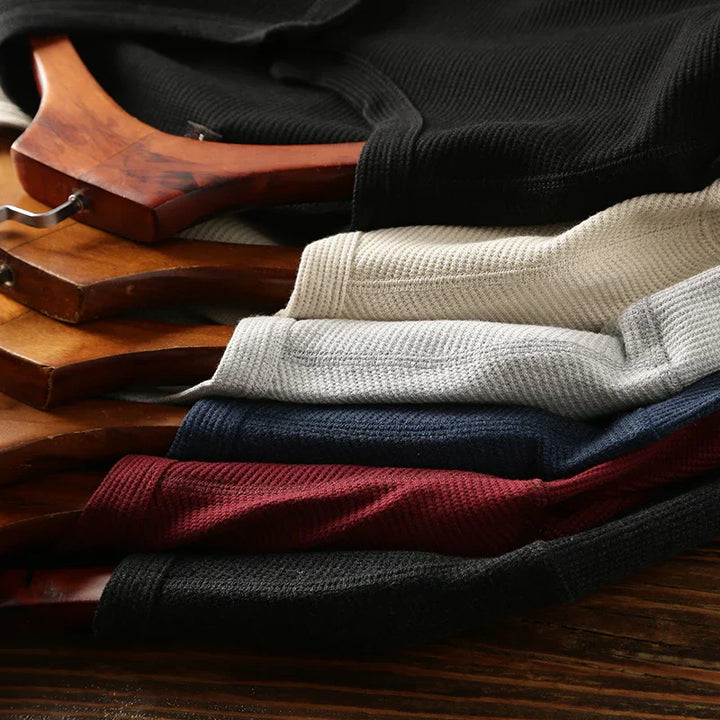 Buttons on men's waffle knit Henley shirt, highlighting smart casual design & comfort.