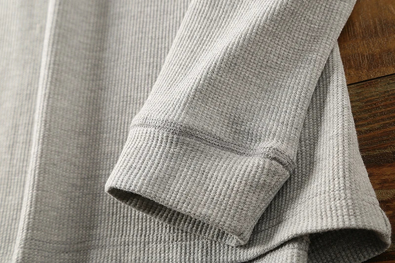 Men's comfortable waffle knit Henley, showcasing versatile breathable long sleeve design.