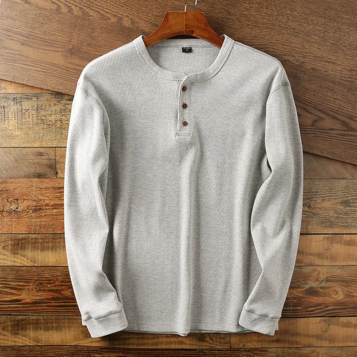 Comfortable men's long sleeve waffle knit Henley, perfect for versatile everyday wear.