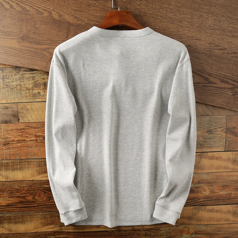 Modern men's minimalist waffle Henley shirt for a smart casual and versatile look.