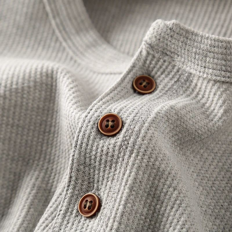 Breathable men's waffle knit Henley, offering comfortable, smart style for all-day wear.