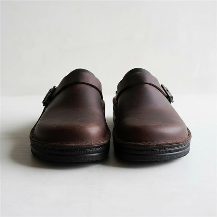 Close-up of the genuine leather texture on men's orthopedic slip-on clogs, emphasizing quality and comfort.