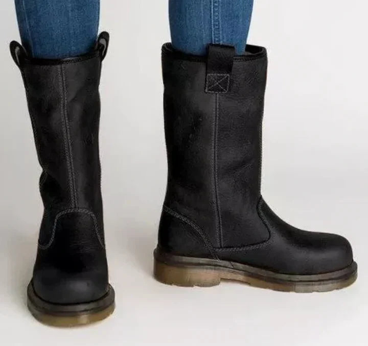 Close-up of men's lined leather work boots, showcasing texture, warmth, and durable outdoor design.
