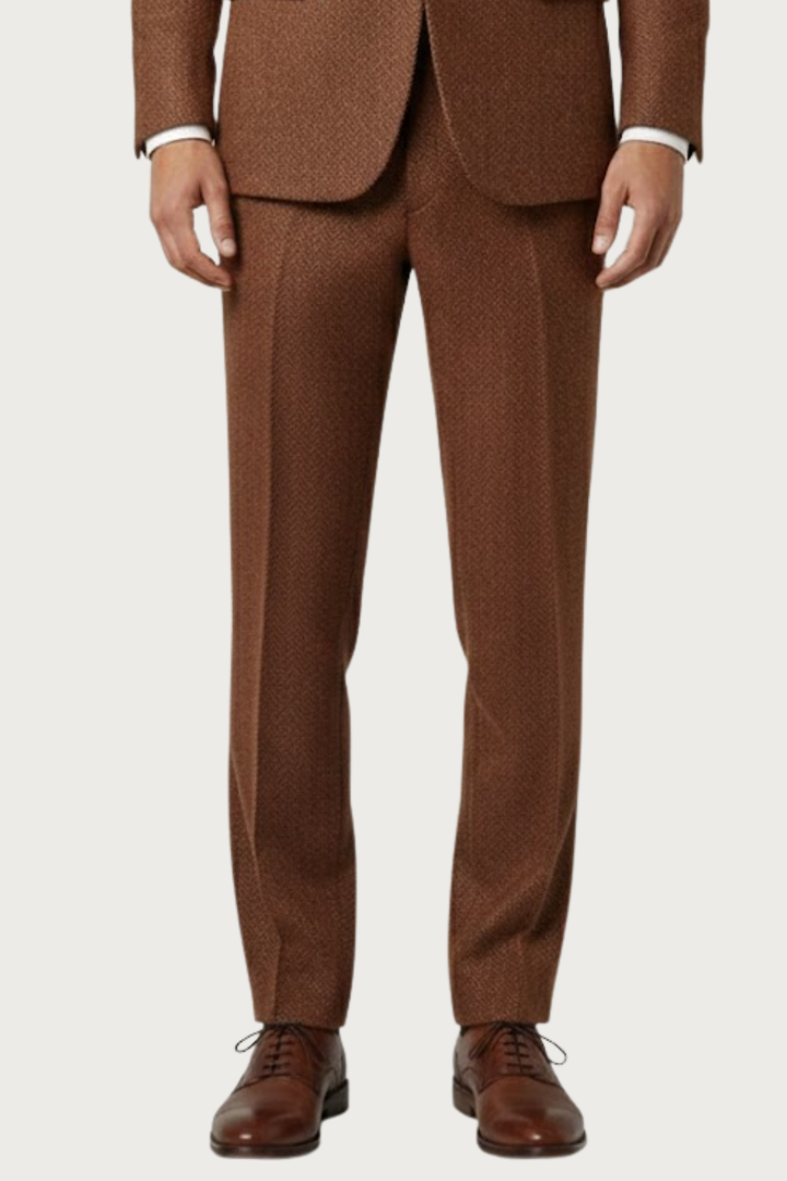 Model wearing a men's two-piece burnt rust single-breasted suit, embodying spring fashion and casual chic.