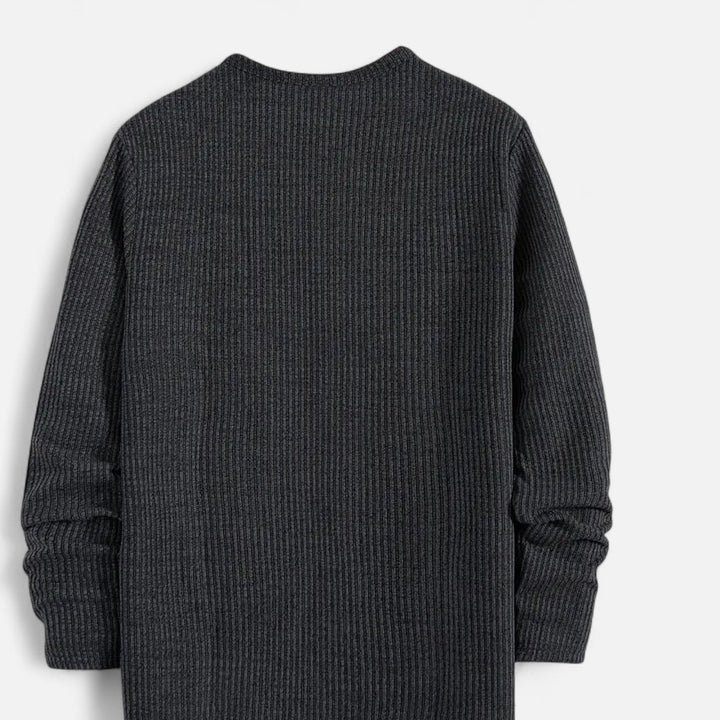 Stylish man wearing a cable-knit henley sweater, long sleeve, ideal for casual autumn and spring outfits.